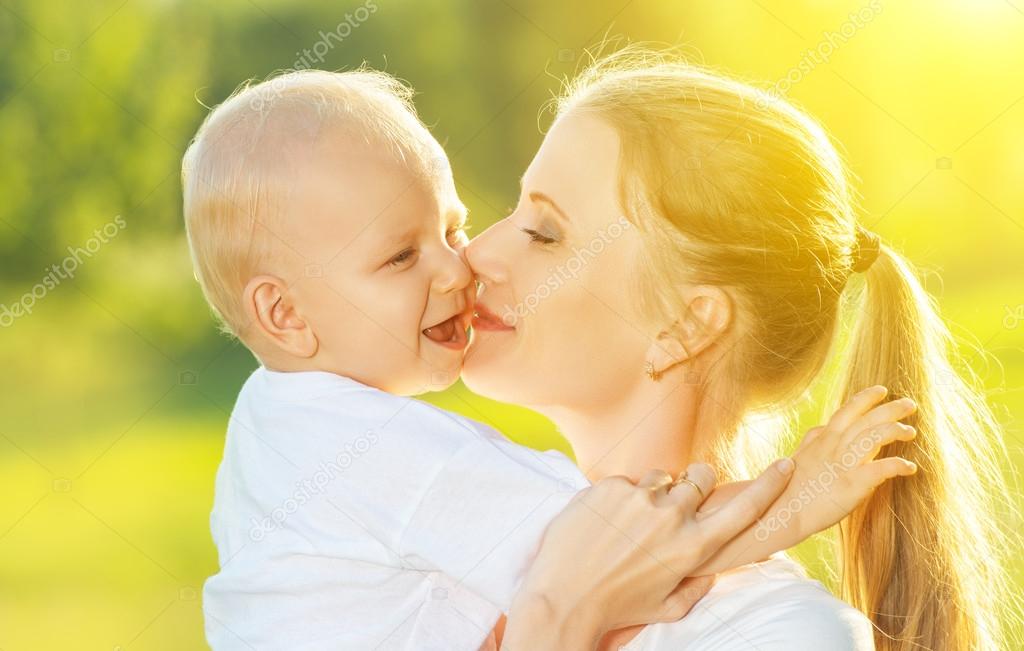 happy family in summer. mother kissing her baby