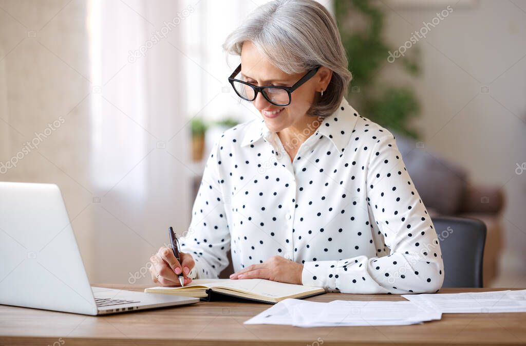 Happy retired pensioner learning studying online on laptop at home