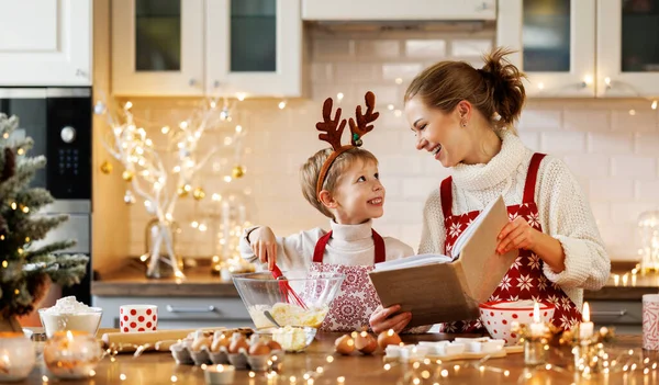 Young smiling woman mother making dough for christmas gingerbread cookies with cute little son — Stock Photo, Image