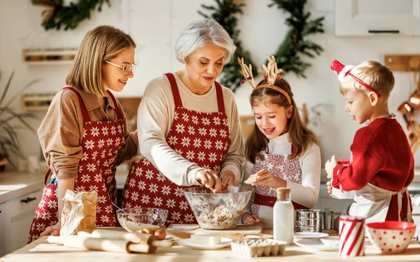 Ευτυχισμένη οικογένεια με παιδιά που μαγειρεύουν μαζί την ημέρα των Χριστουγέννων στη ζεστή κουζίνα του σπιτιού — Φωτογραφία Αρχείου