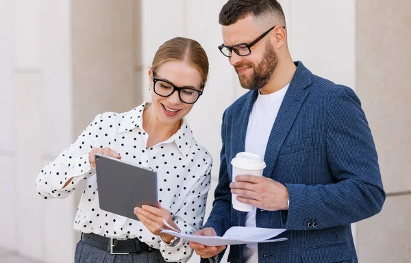 Smiling business colleagues dressed in formal clothes discussing work while standing outside — Stock Photo, Image