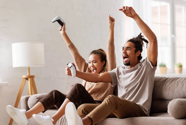 African american couple laugh and play video games together using a video game console — Stock Photo, Image