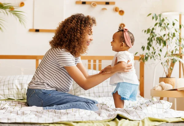 Happy Ethnic Curly Mom Playing Laughing Little Baby Daughter Bed — Stock Photo, Image