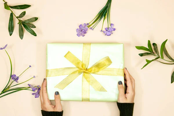 Woman Hands Holding Rectangular Gift Decorated Yellow Ribbon Pastel Pink — Zdjęcie stockowe