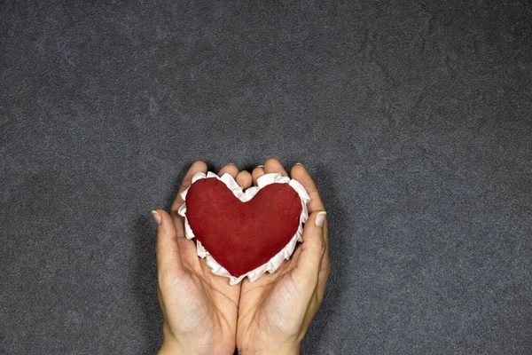 hands holding red heart , health care, love, organ donation, mindfulness, wellbeing, family insurance and CSR concept, world heart day, world health day, National Organ Donor Day, praying concept