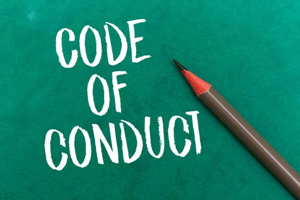 Code Of Conduct concept with pencil on green background