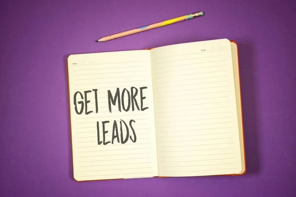 Get more leads concept on notebook or agenda with pencil