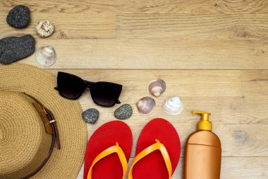 summer concept, sunglasses and hat, sun cream and slipper and stones, selfish 