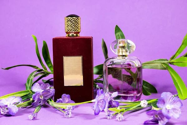 Perfume Bottles Flowers Isolated Purple Background — Stockfoto