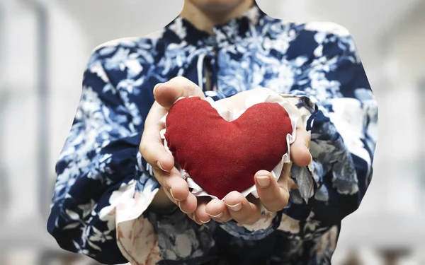 female holding red heart, health care, love, organ donation, mindfulness, wellbeing, family insurance and CSR concept, world heart day, world health day, National Organ Donor Day, praying concept