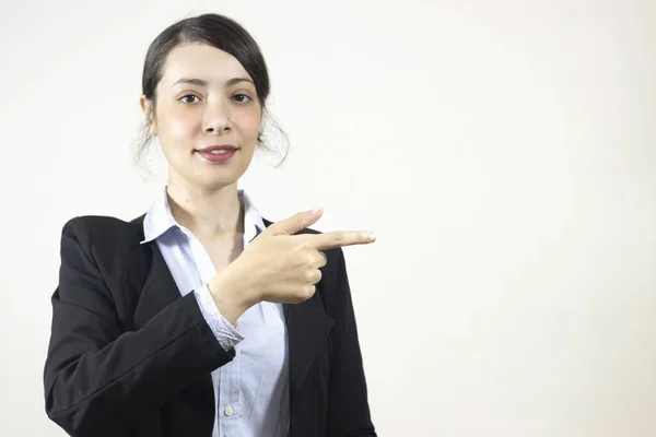 Smiling  business woman pointing her finger and looking at the camera