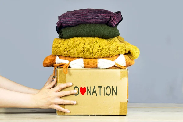 Closeup Woman Hands Holding Carton Box Used Clothes Donation Collection — Stockfoto