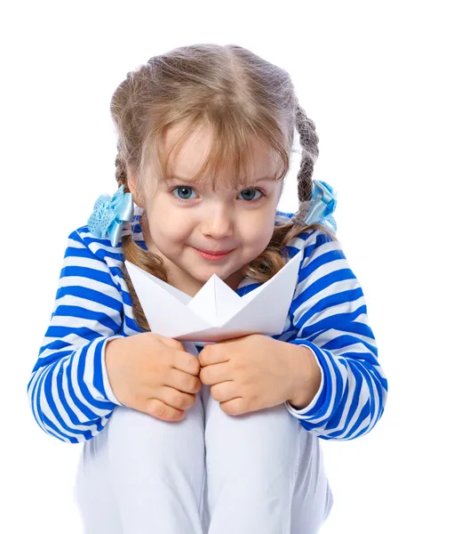 Ritratto di una bambina che regge una barca di carta su uno schienale bianco Fotografia Stock