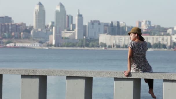 Girl on a background a motor-car bridge in the distance — Wideo stockowe