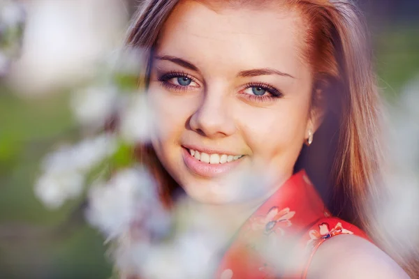Girl in the flowers of cherry — Stock Photo, Image