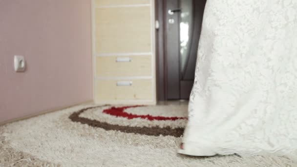 Bride in a wedding dress expensive out of the room — Stock Video