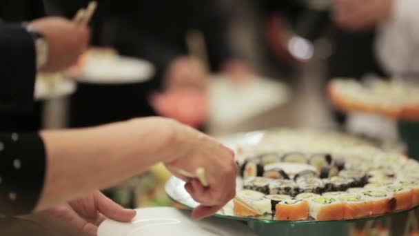 客人在一个节日的鸡尾酒会上采取寿司 — 图库视频影像