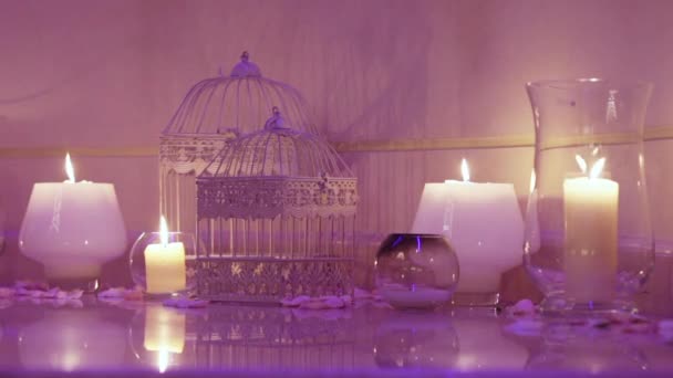 Group of burning candles with decorative cage — Stock Video