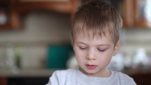 A sick child licks his fingers in sour cream — Stock Video