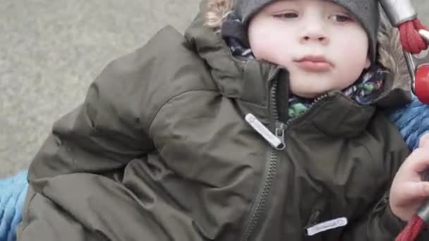 Boy monta em um balanço de malha redonda — Vídeo de Stock