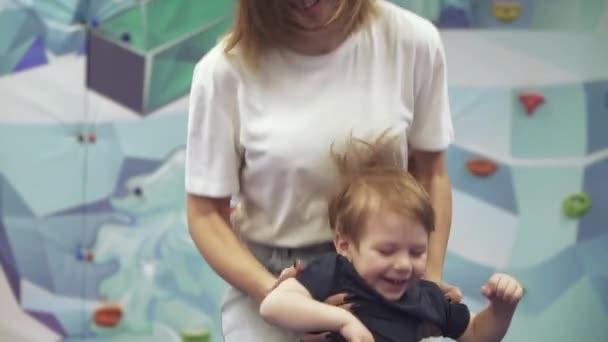 Mamma med son på studsmatta — Stockvideo