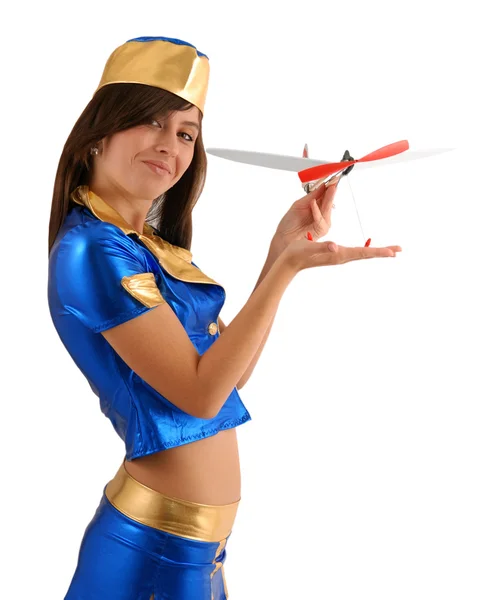 Woman in blue suit with small aircraft, sideview — Stock Photo, Image