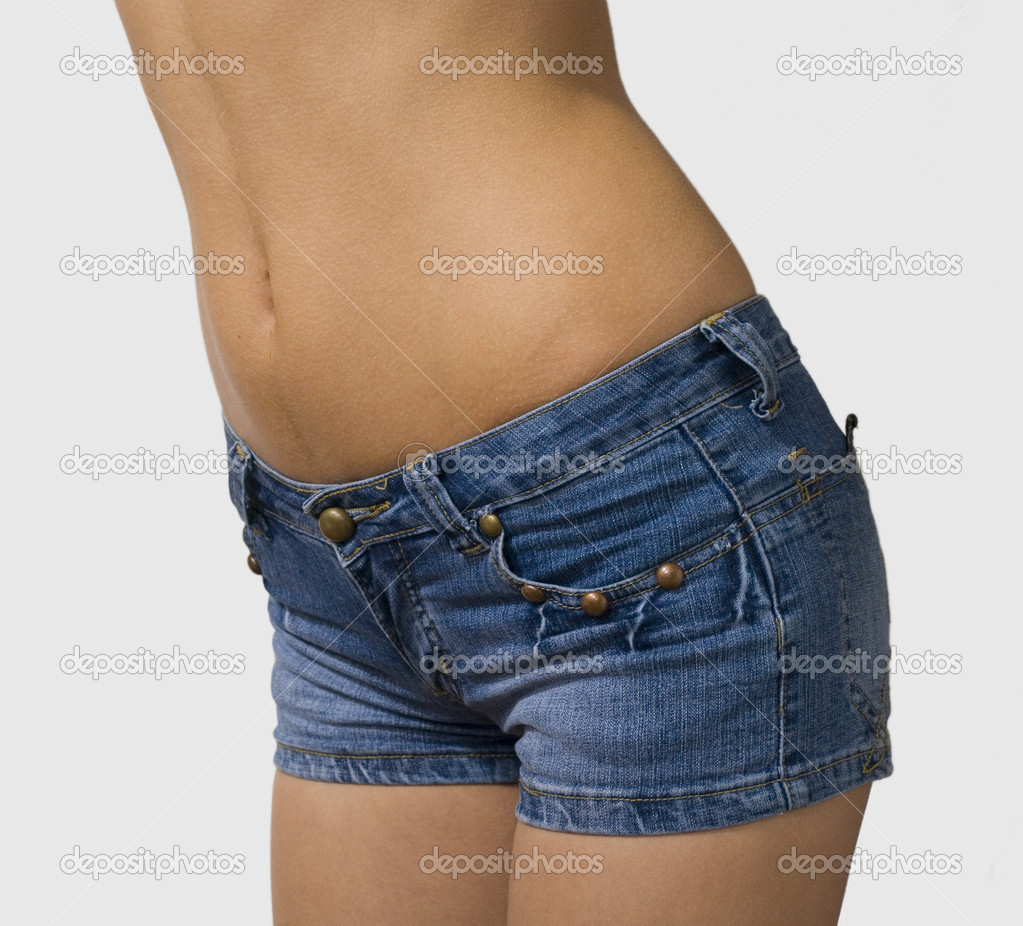 Nude belly of girl in blue jeans shorts isolated