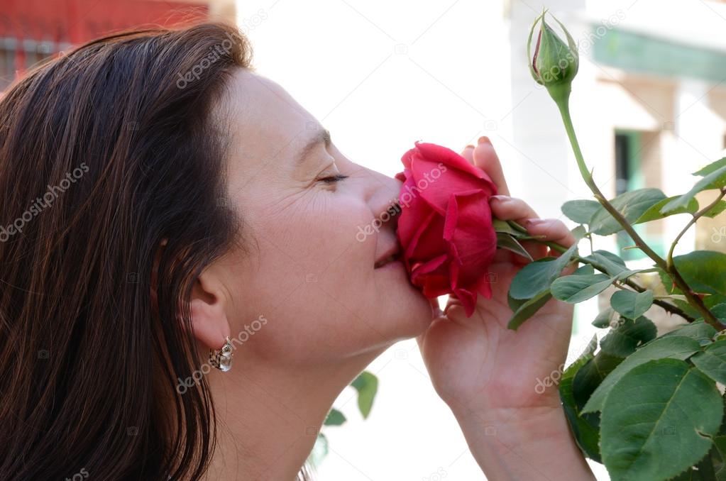 Woman snuggling up to the flower