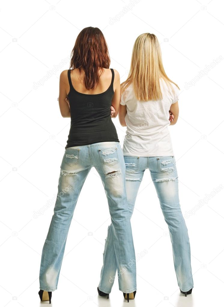 Rear view of two sexy women in jeans