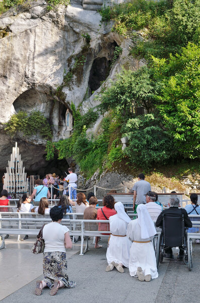 Believers near the Grotto in Lourdes