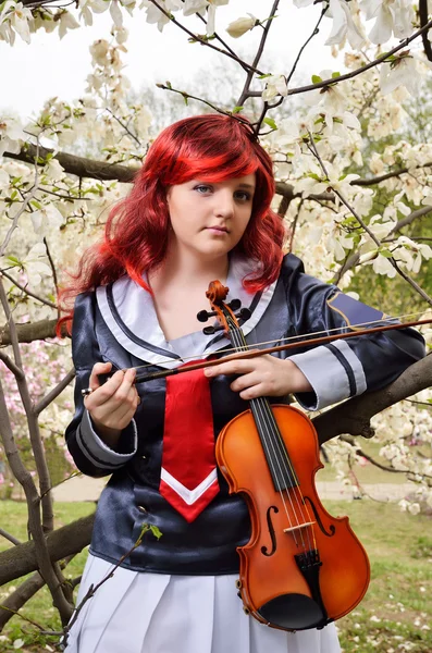 Adolescente avec un violon dans le jardin fleuri — Photo