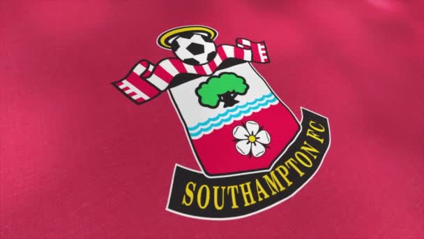 Abstract logotype of Southampton football club on pink waving flag background. Motion. Professional sport club emblem. For editorial use only. — Stock Video