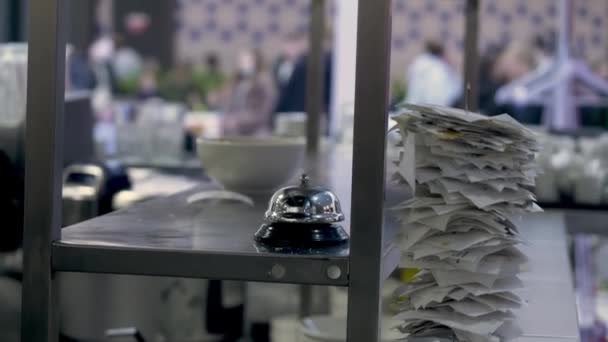 Gros plan de la pointe en métal avec de nombreux reçus en papier dessus. HDR. Intérieur d'un restaurant ou d'une cuisine de café, main de serveuse prenant un plat. — Video