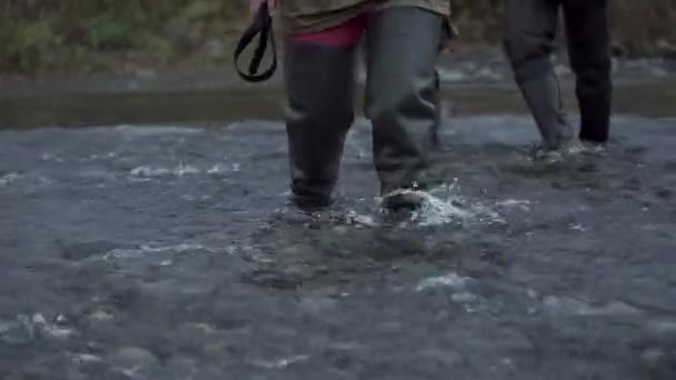 Przepływ pracy. Klip. Mężczyzna w specjalnych ciuchach spacerujący wzdłuż rzeki z kolegami. — Wideo stockowe