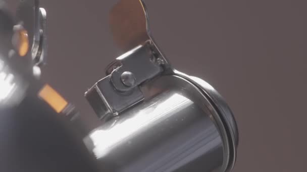 Close up de fiação curto bico fechado de uma chaleira de prata de metal no fundo da parede cinza borrada. Acção. Spinning bule novo. — Vídeo de Stock