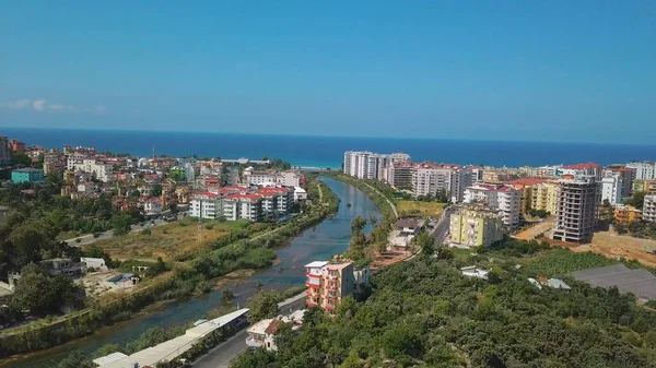 The view from the drone. Clip. View of the blue clear ocean near the resort area with a swimming pool and houses . — Stock Photo, Image