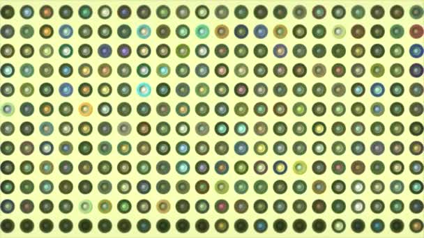 Lots of flashing dots with different colors. Motion. Disco dots flashing with different colors. Colorful mosaic dots with rings on solid background — Vídeo de Stock