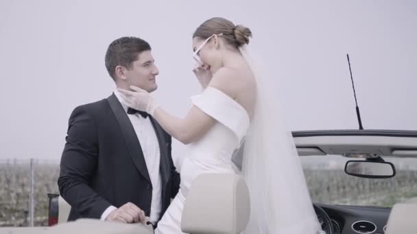 Wedding photography. Action. A wedding in nature with two young and beautiful people, some are photographed in the forest and others next to the car and the bride in glasses. — Wideo stockowe