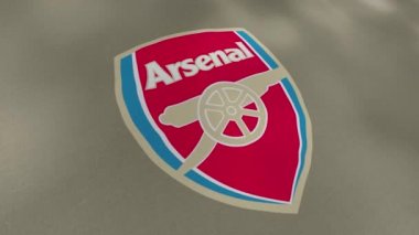 Arsenal futbol takımının logosu olan bayrak sallıyor, yakın plan. Hareket. Renkli profesyonel İngiliz futbol kulübü bayrağı, kusursuz döngü. Sadece yazı işleri için..