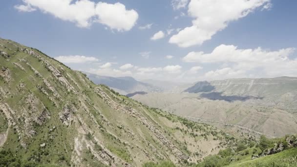 Vista panorâmica. Acção. Bela vista de verão das montanhas com vegetação verde sobre um céu claro azul brilhante. — Vídeo de Stock