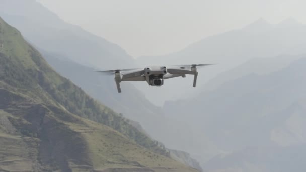 Un dron volador en el aire. Acción. Drone vuela sobre el hermoso paisaje de montaña en un día soleado. Drone en el aire dispara paisaje de montaña — Vídeo de stock