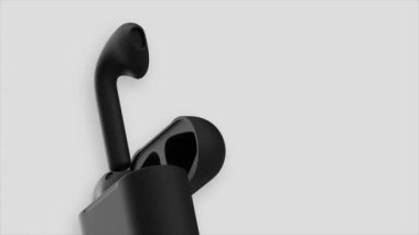 Beyaz arka planda izole edilmiş kablosuz siyah müzik kulaklıkları. Hareket. Modern kulaklıkların yeni tasarımı.