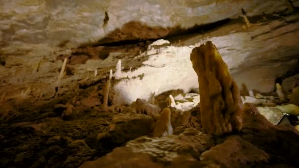 View inside of underground cave, concept of adventure and speleology. Action. Rocks and sunshine inside a cave. — Stock Video