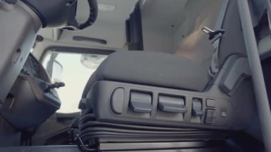 KAMAZ kulübesinin içi. Sahne. Düğmeye basılır ve sandalye kalkar. Kamyonun alt kısmının iç kısmı. Siyah koltuklar ve siyah iç mekan