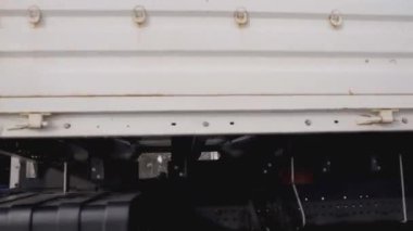 Rusya, MOSCOW - 21 Mart 2022: büyük beyaz bir kamyon yol boyunca ilerliyor. Sahne. Siyah tekerlekler Kamaz 'a yakın çekim. Beyaz kamyon kışın yola çıkar. Çerçevede bir sürü kamyon tekerleği var.