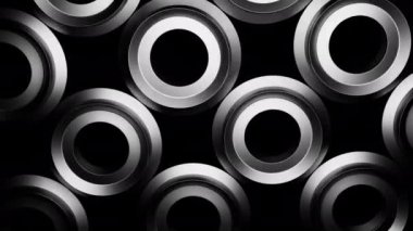 Hipnotik etkisi olan üç boyutlu halkalar. Tasarım. Üç boyutlu fındıklar siyah arka planda titreşiyor ve hipnotize oluyor. Metalik parıltılı fındık ya da halkalar hipnotize edici bir şekilde döner.