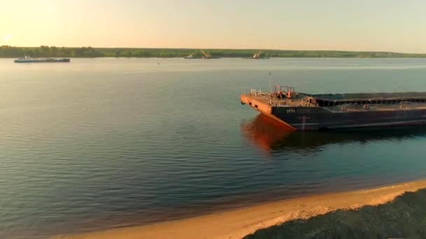 Chiatta da carico ormeggiata sulla riva del fiume su sfondo cielo limpido. Scena. Concetto di trasporto per via navigabile. — Video Stock