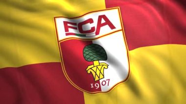 Alman futbol takımının amblemli 3D bayrağı. Hareket. Güzel, parlak bayrak, futbol takımının logosuyla rüzgarda sallanıyor. Augsburg futbol takımının arması ve bayrağı.