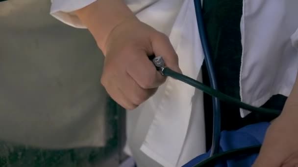 Kan basıncını ölçün. Şarjör. Beyaz gömlekli bir adam kan basıncını bir tonometreyle ölçüyor. Tıp konsepti.. — Stok video