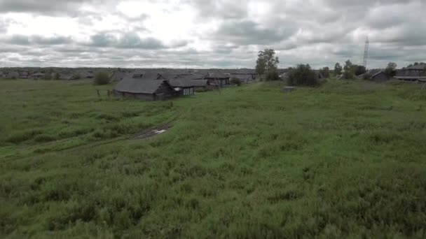 夏の日には田園地帯の空中ビュー. ストック映像。 緑の牧草地と木々に囲まれた木造の古い家. — ストック動画